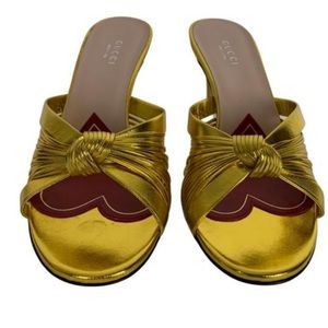 GUCCI Metallic Nappa Crawford Knotted Mid Heel Slides Gold 3-inch kitten heel.